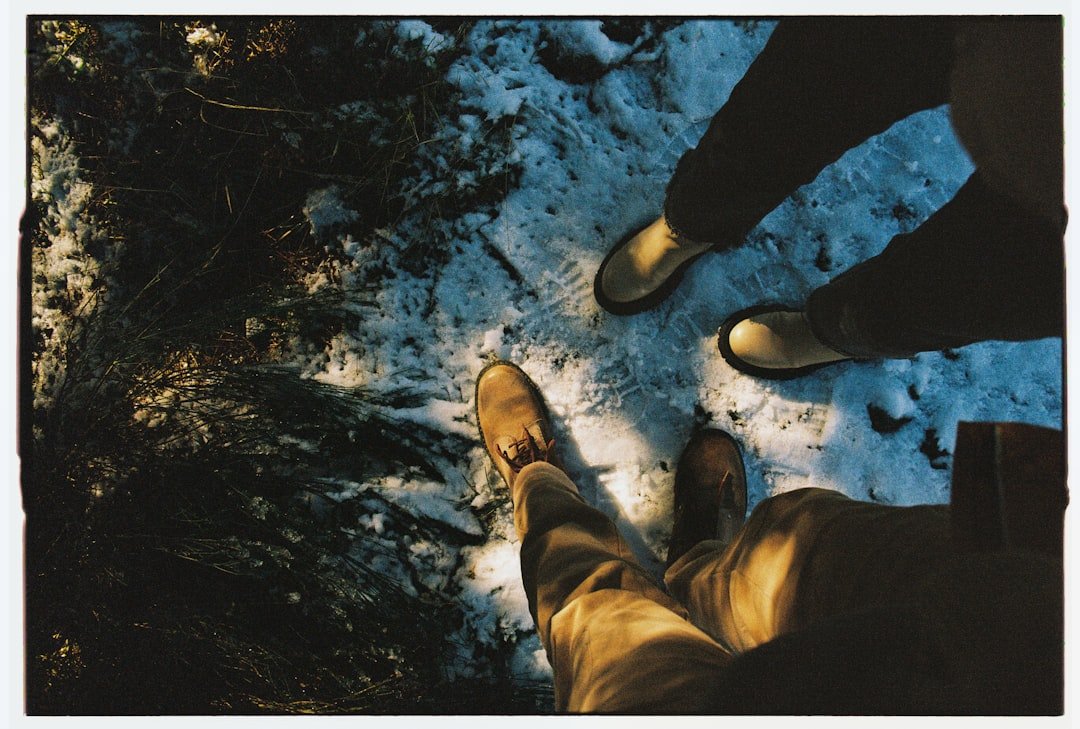 Two people standing in a snowy forest