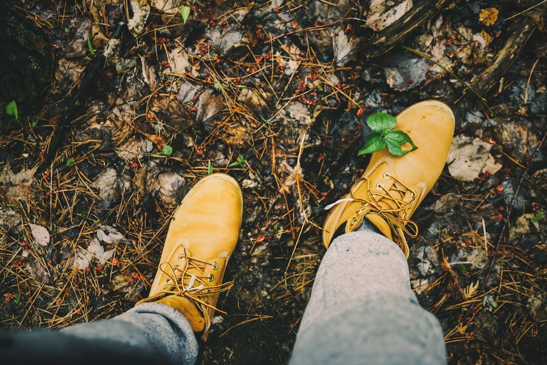 person wearing yellow work boots
